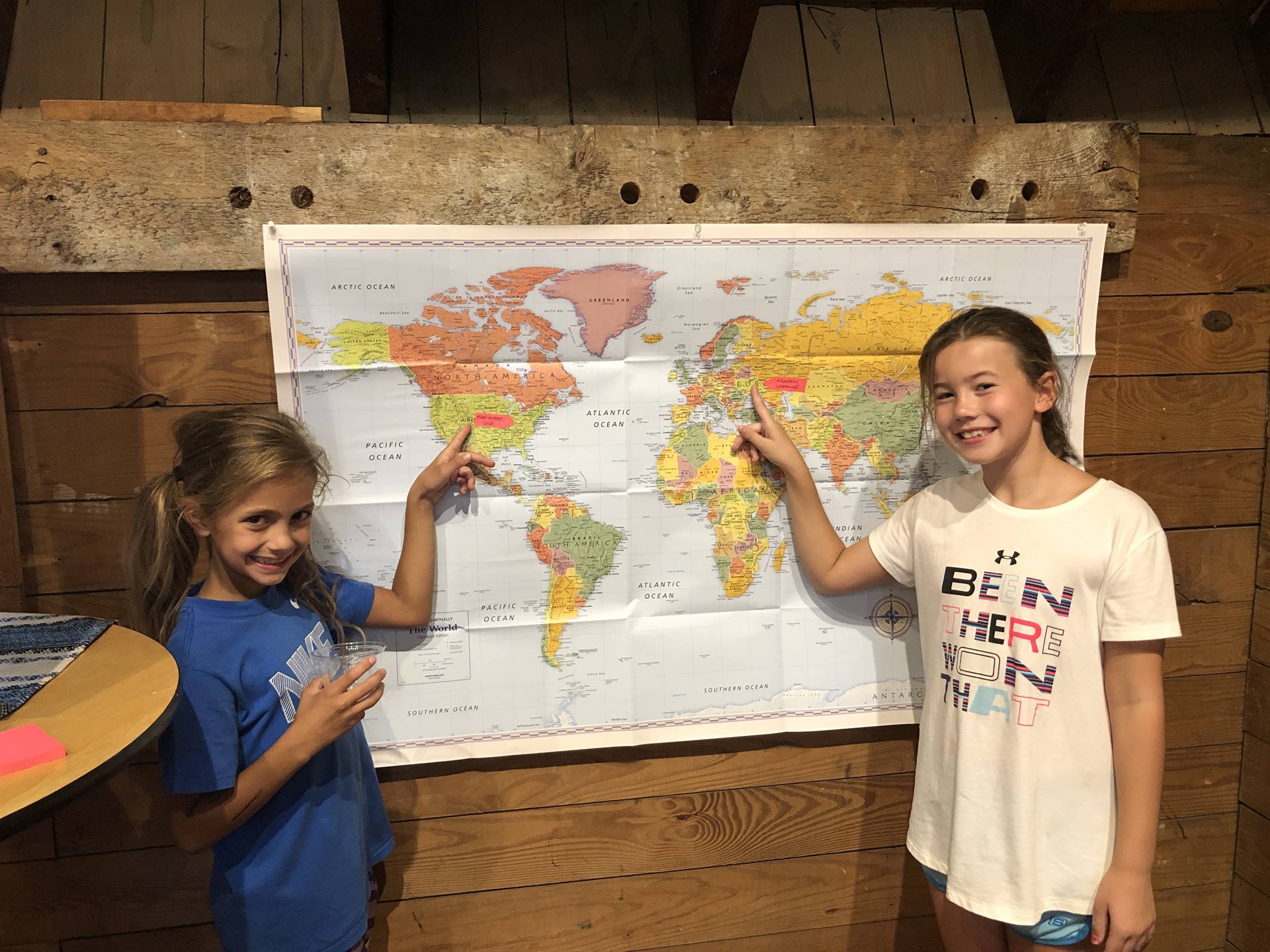 students pointing to map