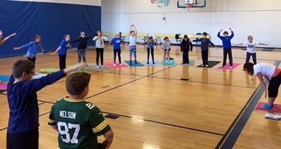 Students stretching in a gym